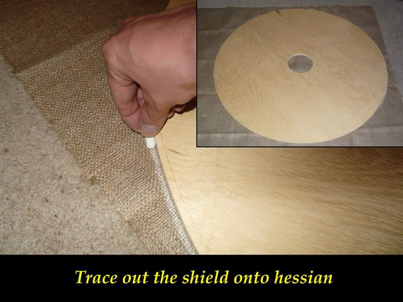 Trace out the shield onto the fabric