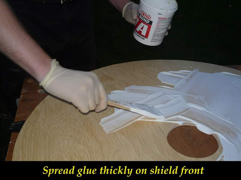 Spread glue thickly on shield front